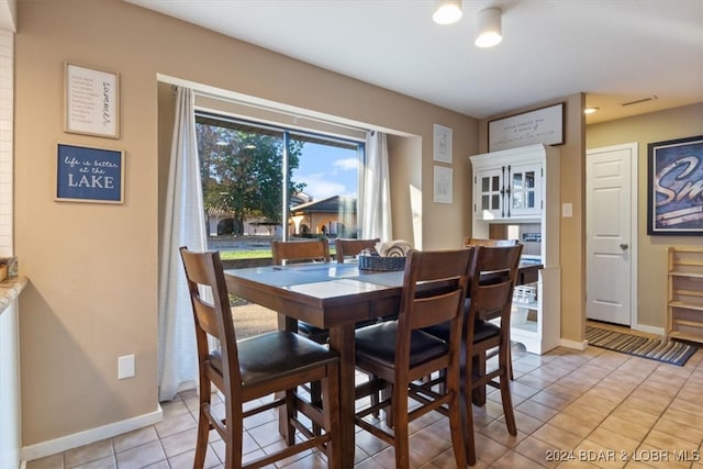 dining space with light tile patterned floors