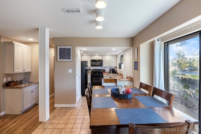 dining room featuring light hardwood / wood-style flooring and sink