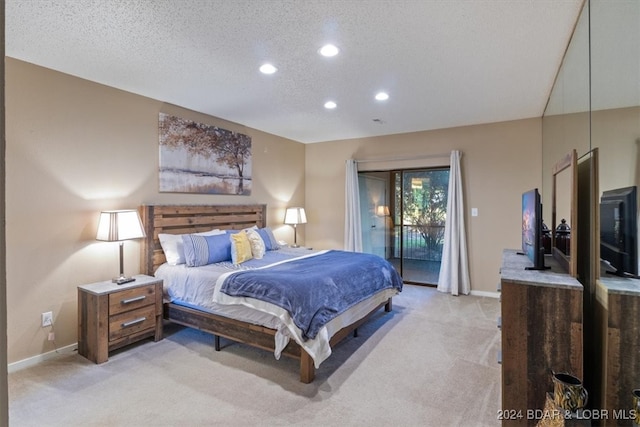 carpeted bedroom with a textured ceiling and access to exterior