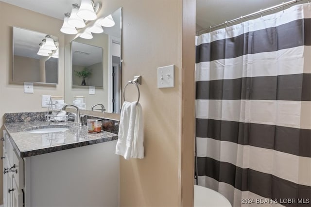 bathroom featuring vanity, toilet, and a shower with shower curtain