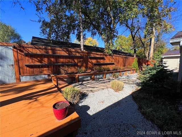 view of yard featuring fence and a wooden deck