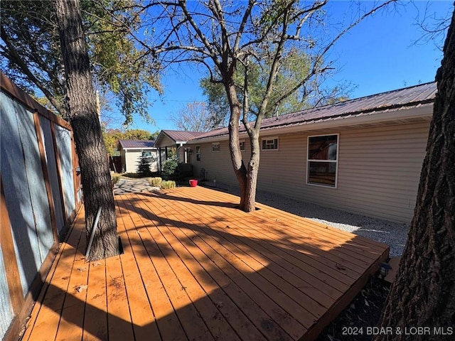 wooden deck with fence and an outdoor structure
