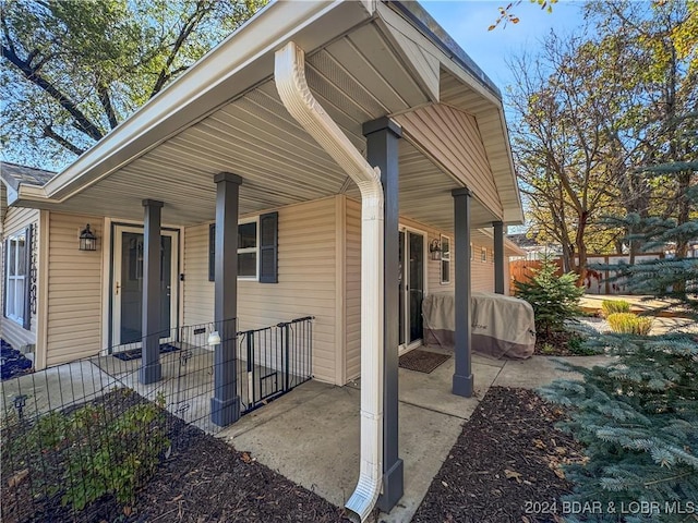 exterior space featuring fence and covered porch