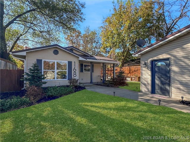 ranch-style home featuring a patio and a front lawn