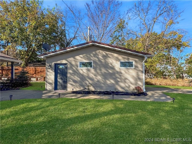 view of outbuilding featuring fence