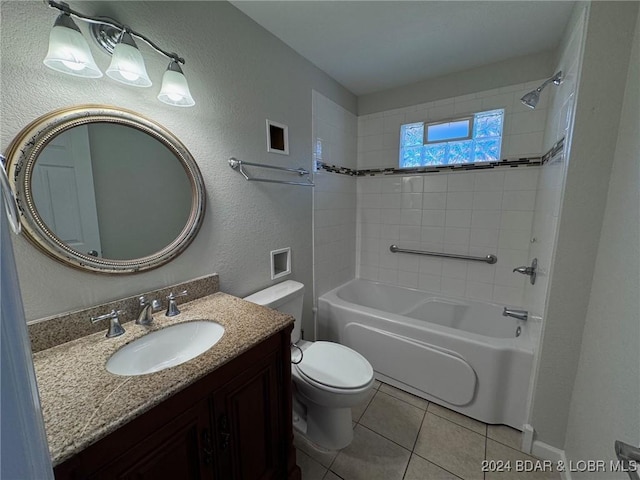 full bath featuring vanity, a textured wall, bathing tub / shower combination, toilet, and tile patterned floors