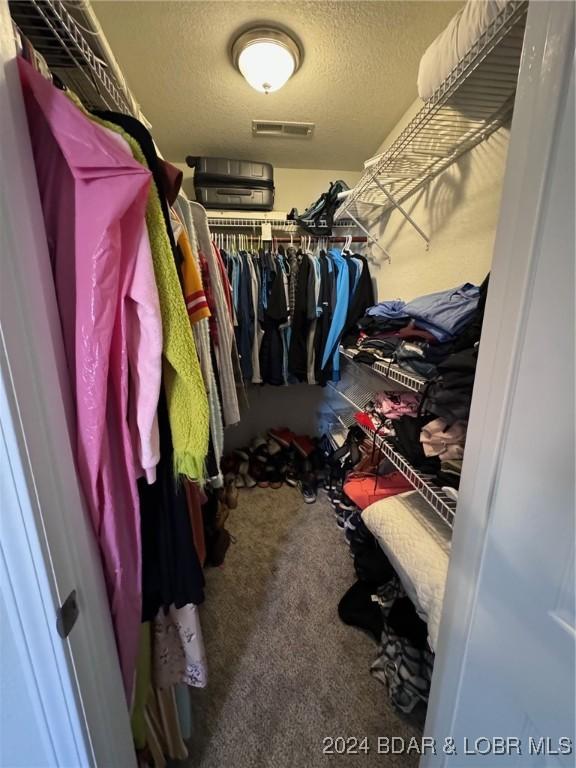 walk in closet with carpet flooring and visible vents
