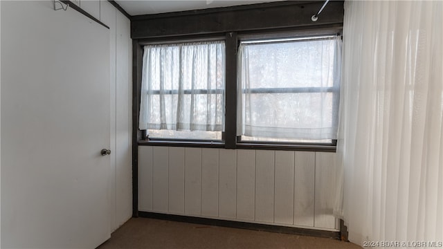 empty room featuring wooden walls