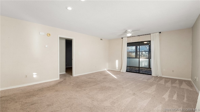 spare room with light carpet and ceiling fan