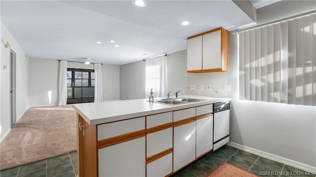 kitchen with sink, white cabinetry, kitchen peninsula, and dishwasher