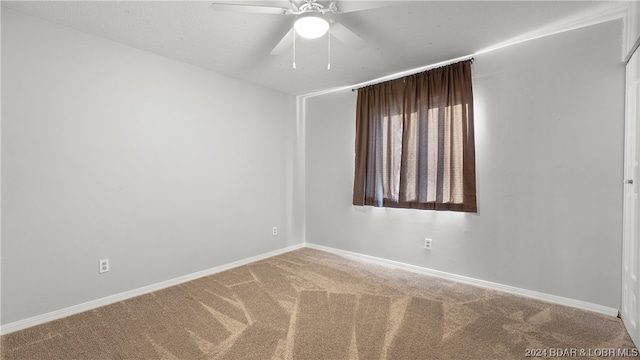 carpeted empty room with ceiling fan