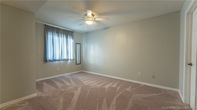 unfurnished room with carpet, a textured ceiling, and ceiling fan