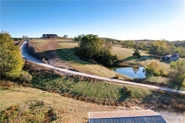 exterior space featuring a rural view and a water view