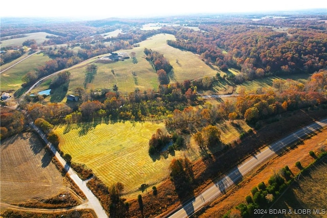 birds eye view of property with a rural view