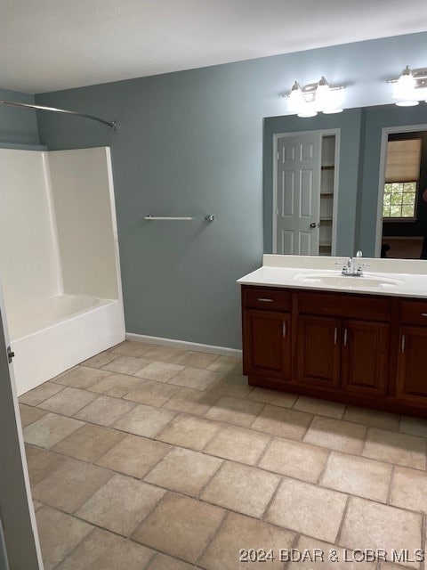 bathroom featuring vanity and shower / tub combination