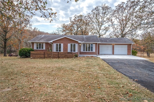 ranch-style house with a front yard and a garage