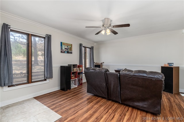 living room with crown molding, dark hardwood / wood-style floors, and ceiling fan