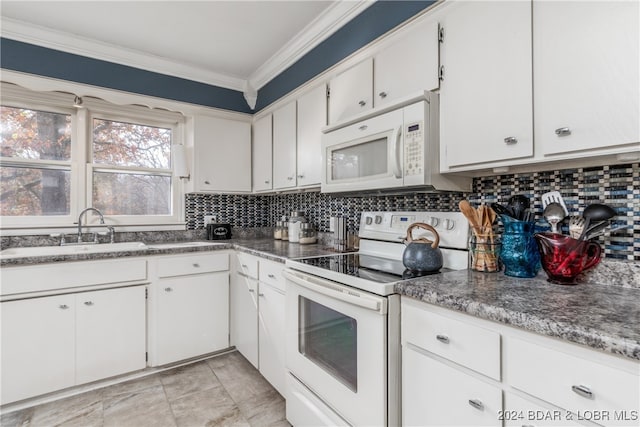 kitchen with ornamental molding, sink, white cabinets, and white appliances