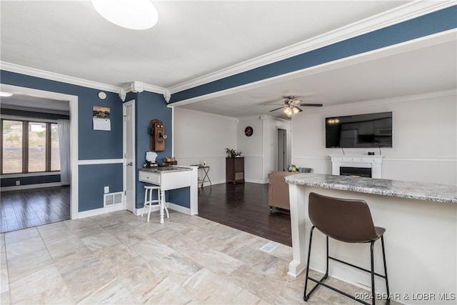 kitchen featuring light hardwood / wood-style floors, ornamental molding, and ceiling fan