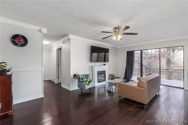 living room with ceiling fan, ornamental molding, and dark hardwood / wood-style flooring