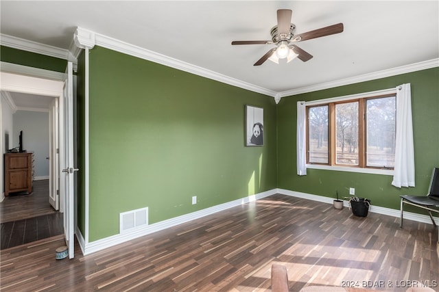 interior space featuring dark wood-type flooring, crown molding, and ceiling fan