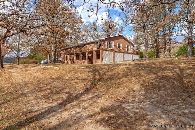 rear view of house featuring a wooden deck