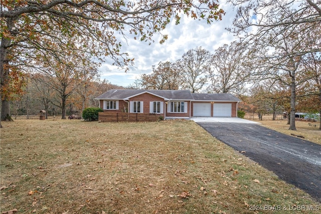 ranch-style home with a front yard and a garage