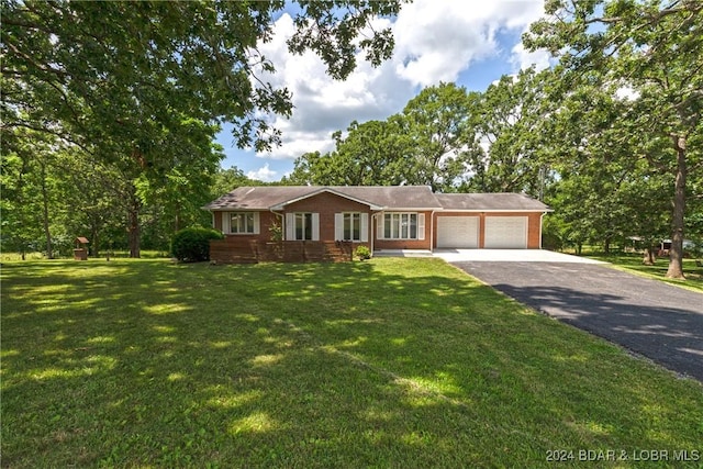 24950 State Rd A Rd, Richland, MO 65556 - single story home featuring asphalt driveway, a garage, a front yard, and brick siding