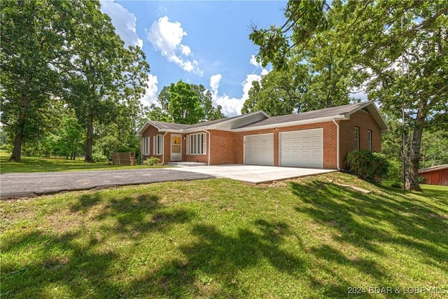 24950 State Rd A Rd, Richland, MO 65556 - single story home featuring driveway, a garage, brick siding, and a front yard