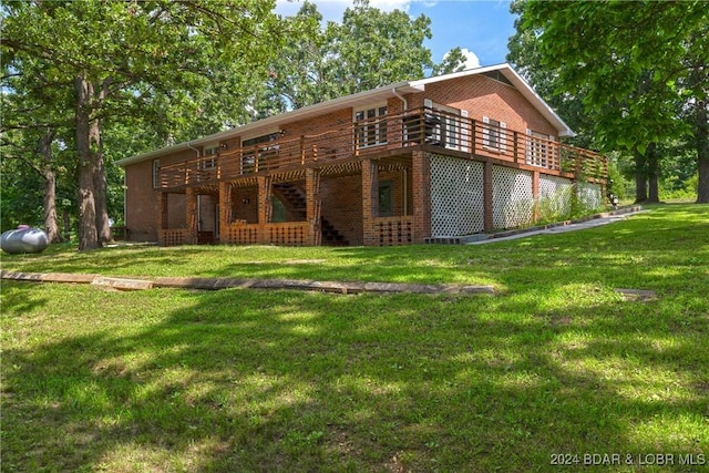 24950 State Rd A Rd, Richland, MO 65556 - back of house featuring brick siding, a wooden deck, and a yard