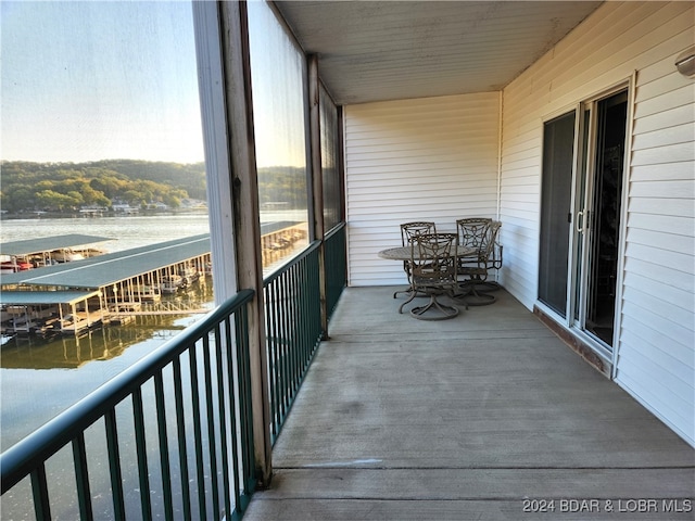 unfurnished sunroom featuring a water view