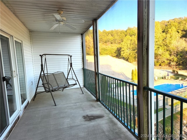 unfurnished sunroom featuring ceiling fan and wood ceiling