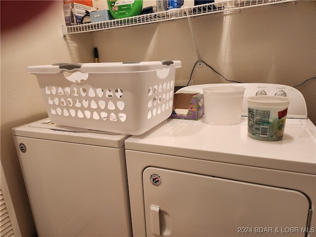 clothes washing area featuring washing machine and clothes dryer