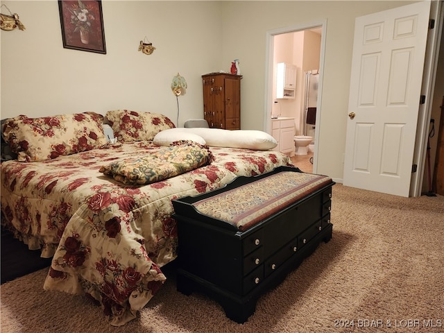 carpeted bedroom featuring ensuite bath