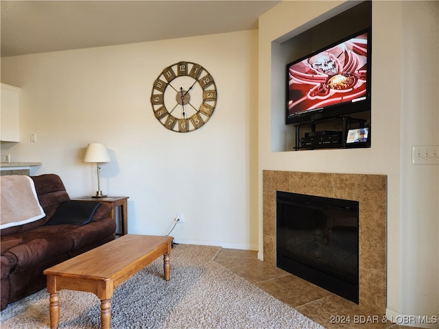 living room featuring light tile patterned flooring and a tiled fireplace