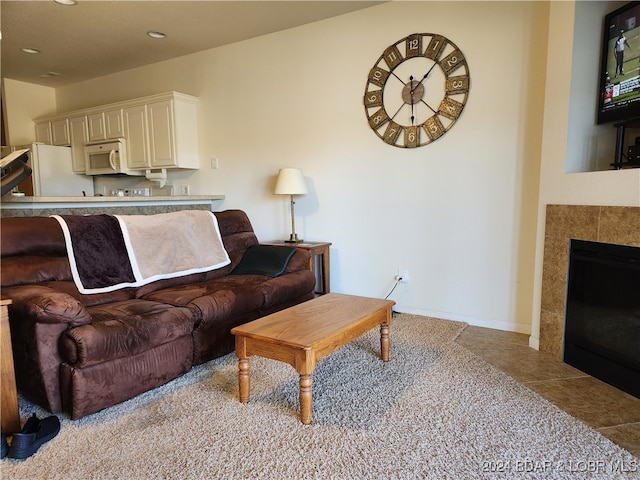 tiled living room featuring a tiled fireplace