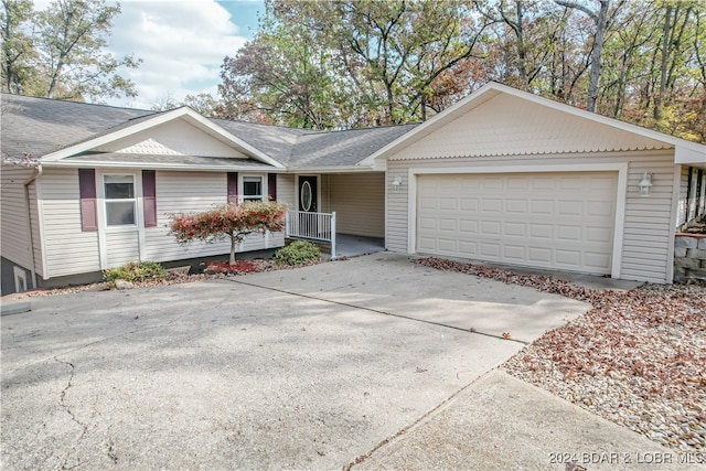 ranch-style house with covered porch and a garage