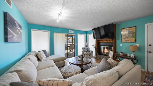 living room with hardwood / wood-style flooring and a textured ceiling