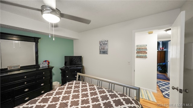 bedroom featuring hardwood / wood-style flooring and ceiling fan