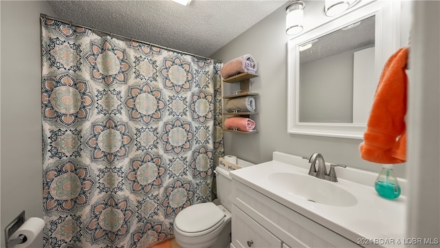 bathroom with vanity, a textured ceiling, toilet, and walk in shower