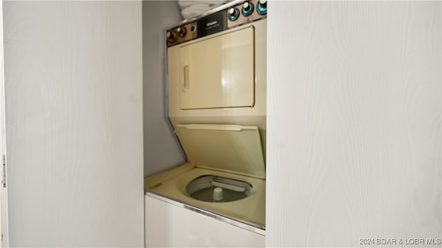 washroom with stacked washer and clothes dryer