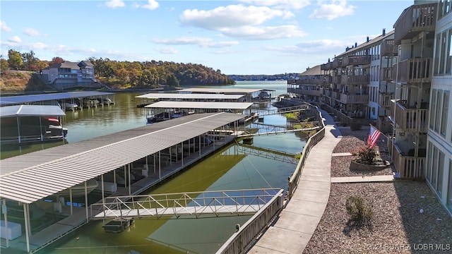 dock area with a water view and a balcony