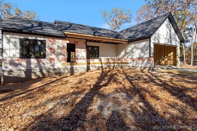 rear view of property featuring a garage