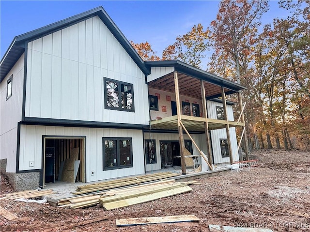 back of house featuring a balcony