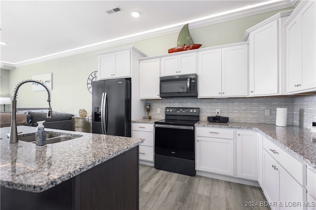 kitchen with black appliances, white cabinetry, sink, and ornamental molding