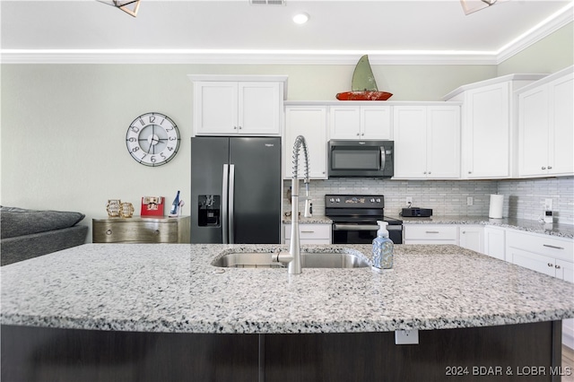 kitchen with crown molding, stainless steel appliances, sink, white cabinets, and a kitchen island with sink