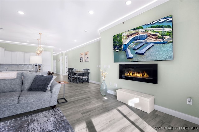 living room featuring hardwood / wood-style floors and ornamental molding