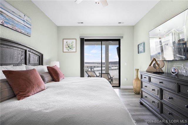 bedroom with ceiling fan, hardwood / wood-style flooring, and access to exterior