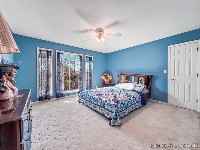 bedroom with light colored carpet and ceiling fan