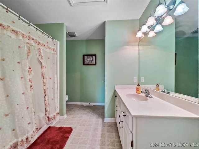 bathroom with toilet and vanity